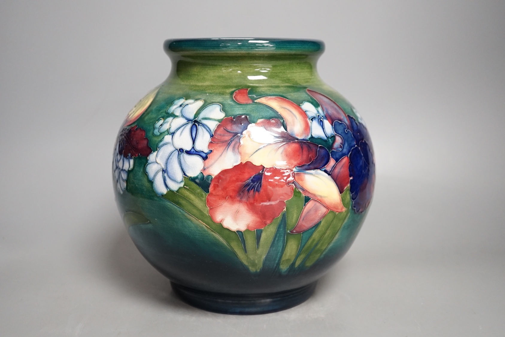 A Moorcroft green glaze 'spring flowers' squat vase, 21 cms high.